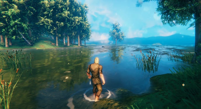 A Valheim screenshot of the player wading into the water and looking out at the sea.